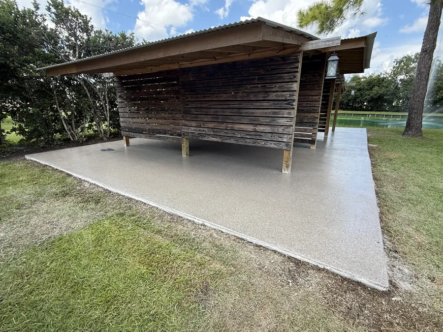 Coated concrete slab beneath a residential backyard shed