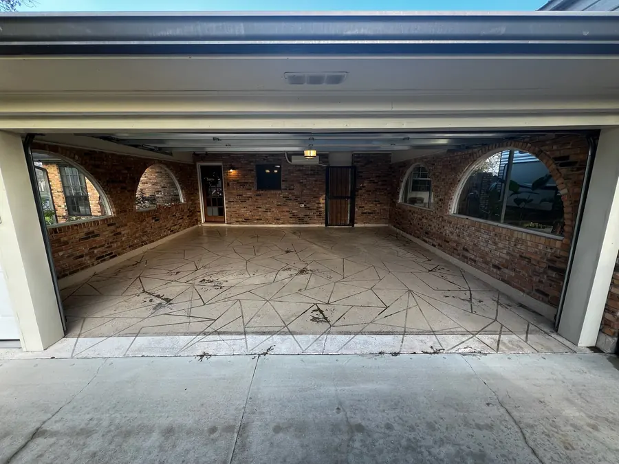 Arched-window garage slab mid-prep with saw cuts