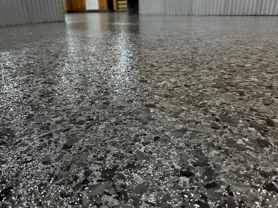 Tight shot of high-gloss grey flake with black and white chips