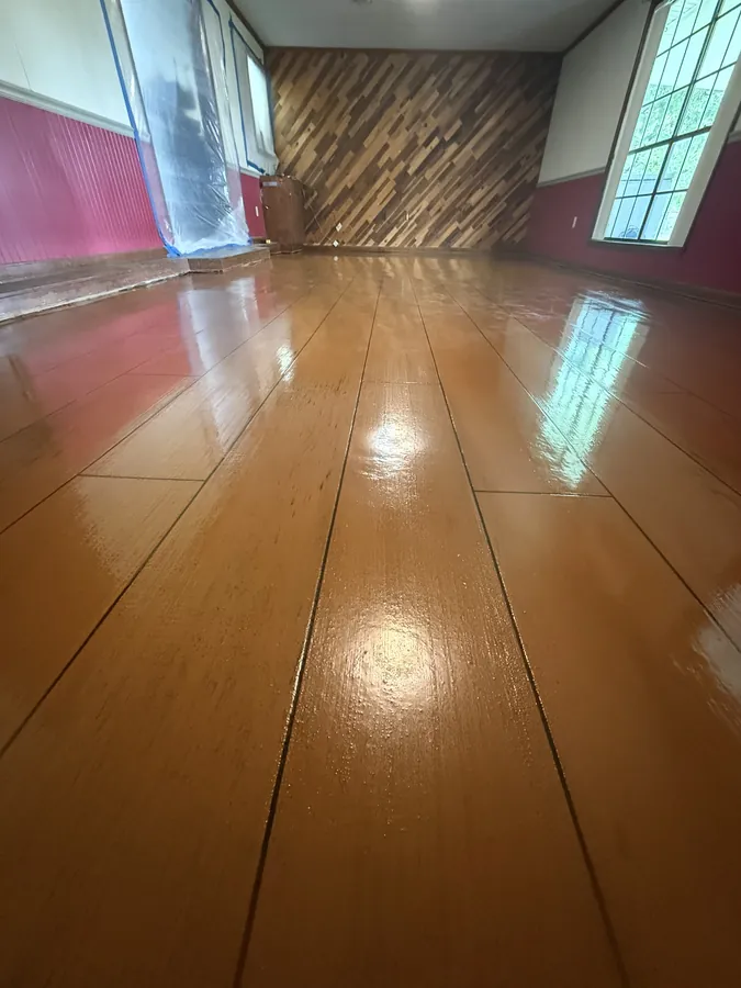 Glossy amber wood plank overlay with a reclaimed wood accent wall