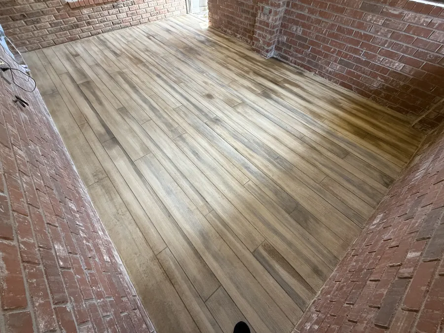 Weathered wood plank overlay between brick walls