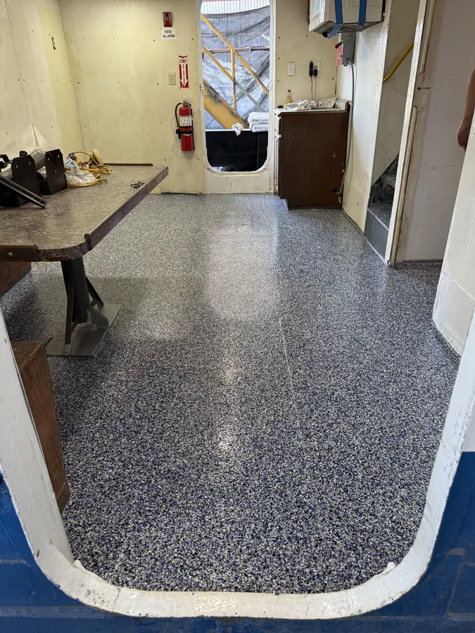 Blue and grey flake flooring system inside a marine vessel