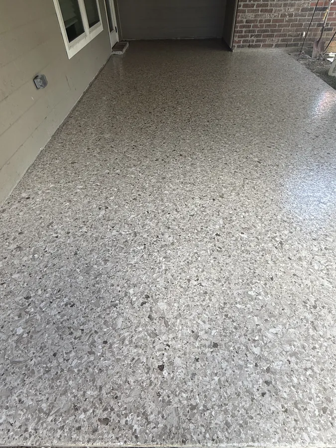 Light flake coating running the length of a covered walkway