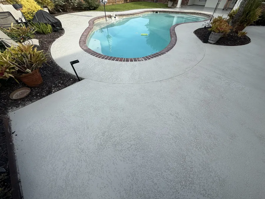 Poolside concrete decking finished in a smooth light coating