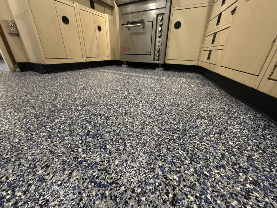 Blue, black and white flake floor in a vessel galley