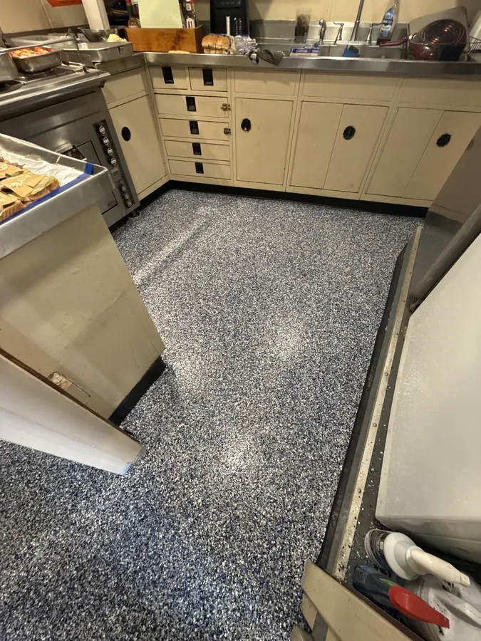 Vessel galley with a new flake floor and black cove base