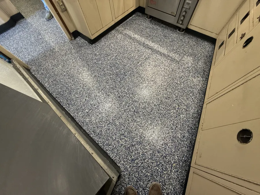 Galley floor coated wall to wall in flake with a cove base