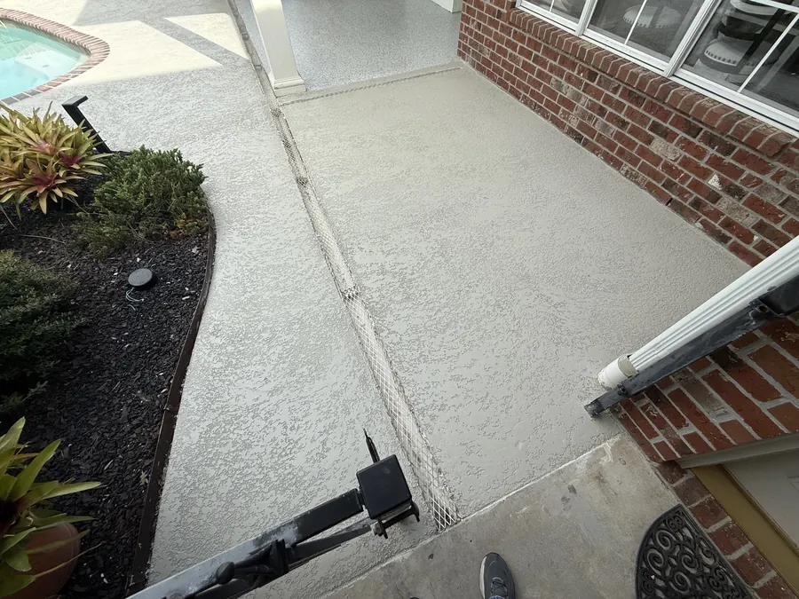 Flake-coated side walkway running along a brick home