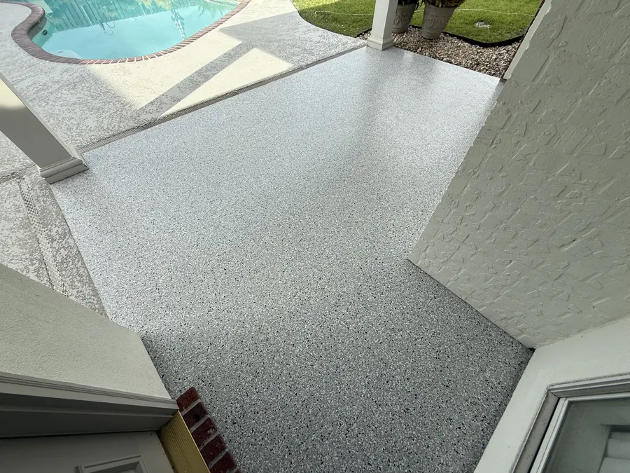 Flake coating wrapping the corner of a pool deck walkway