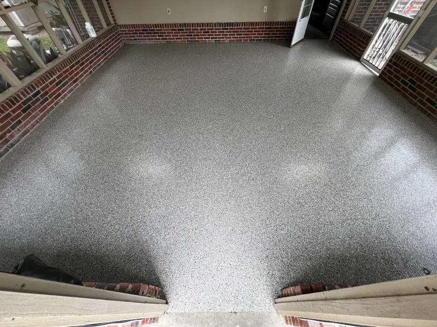 Light grey flake finish across a brick-walled room