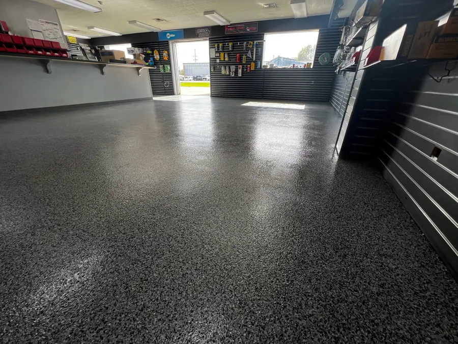 Charcoal flake floor running through a slatwall retail store