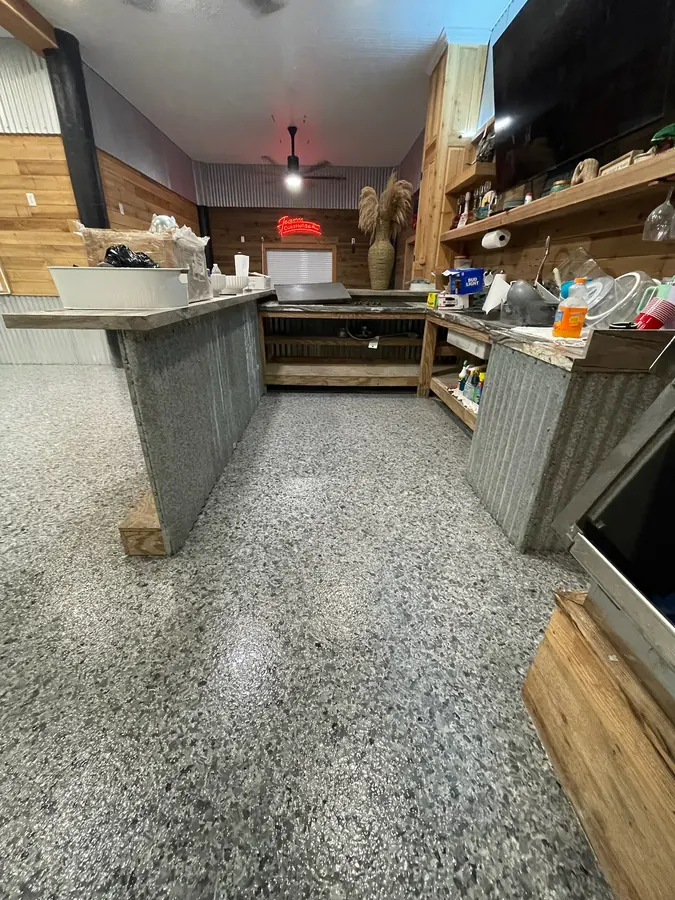 Flake coated floor running along a pine and tin kitchen island
