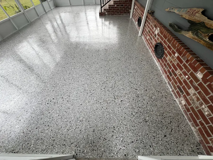 Grey flake floor along a brick accent wall