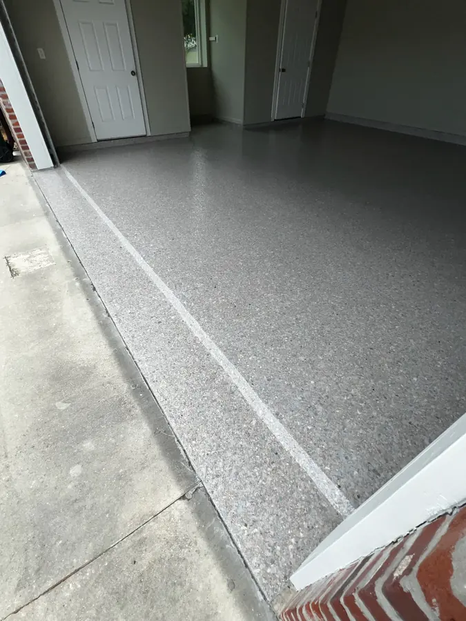 Flake coating finished clean at the garage door