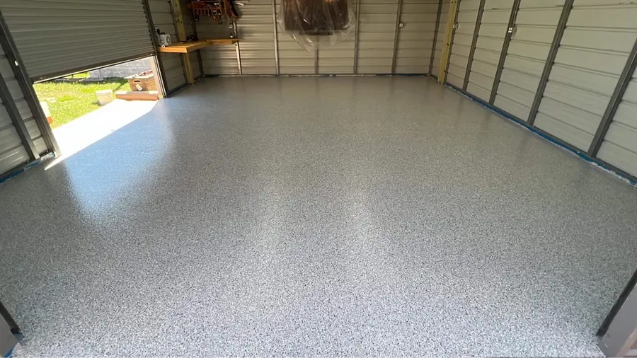 Light flake floor in a garage with a roll-up door