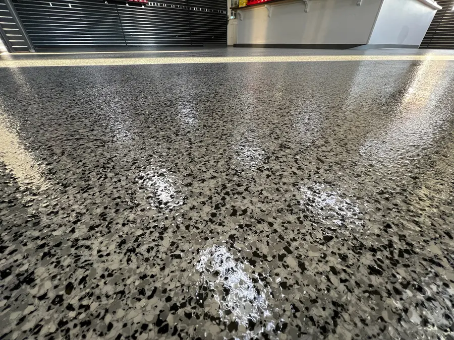 Close-up of black, grey and tan flake under showroom lights