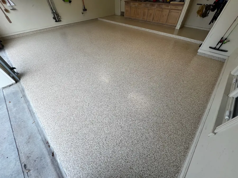 Light tan flake floor running out to the garage door