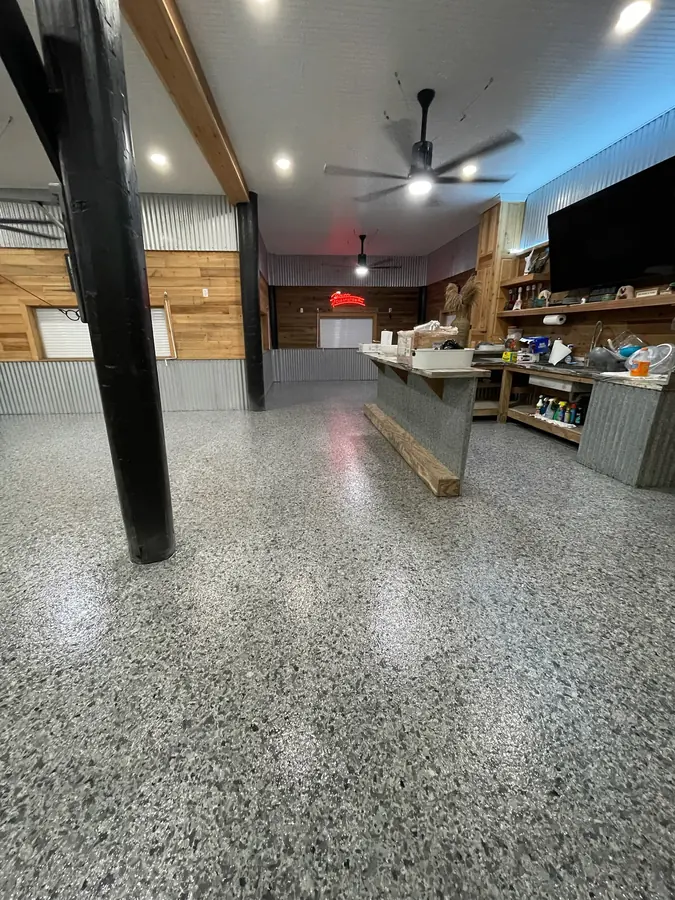 Flake floor wrapping around a post beside the camp kitchen