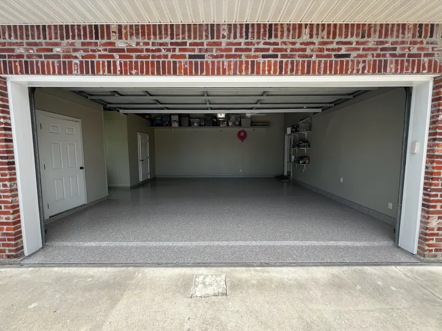 Finished flake garage floor behind a brick front