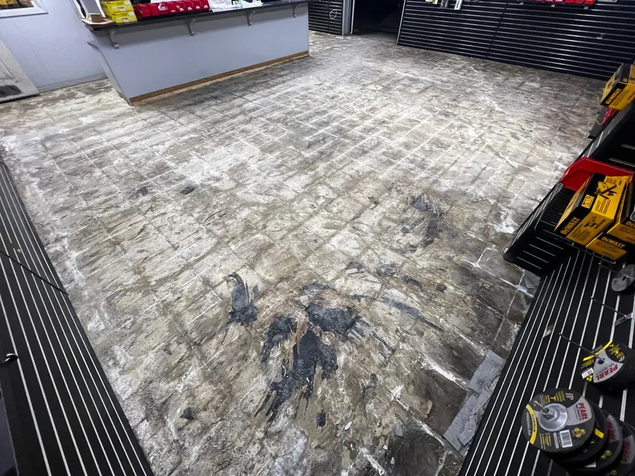 Old showroom flooring stripped off before the new coating