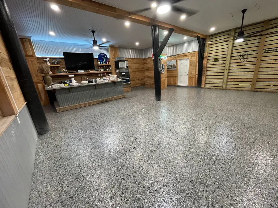 Gloss grey flake floor across an open camp great room